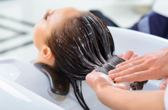 A woman getting her hair washed