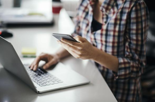 Person Working with Laptop and Mobile Phone