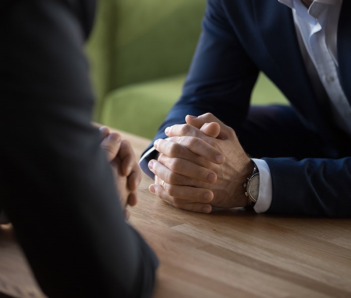 Two men in suits, having a meeting