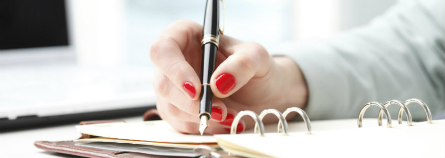 signing a business document notes paperwork
