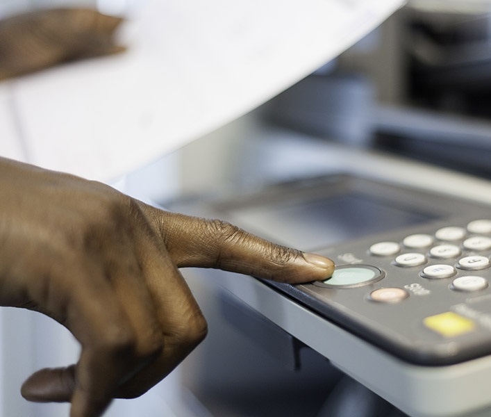 A man using an office printer