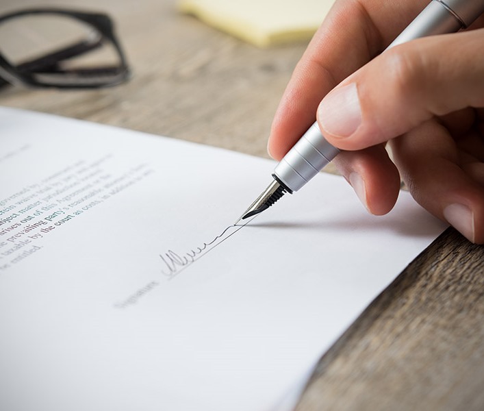 A man signing a contract