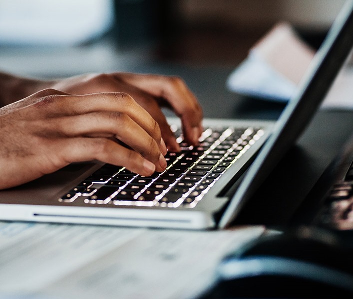 Someone typing on a laptop