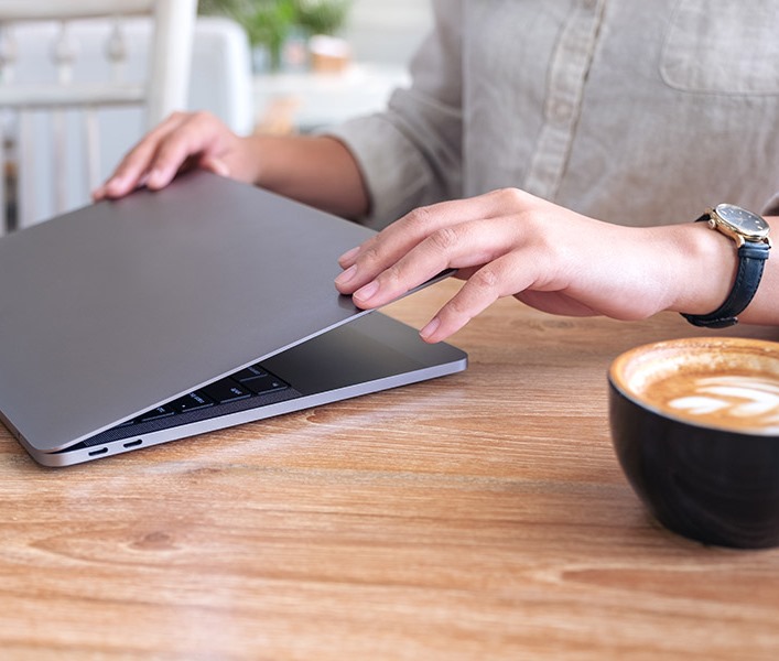 A man closing his laptop