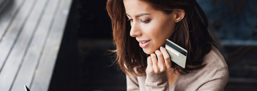 A woman holding a bank card