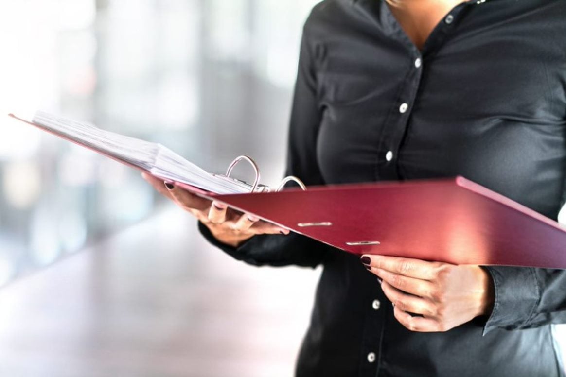 female business founder holding clipboard