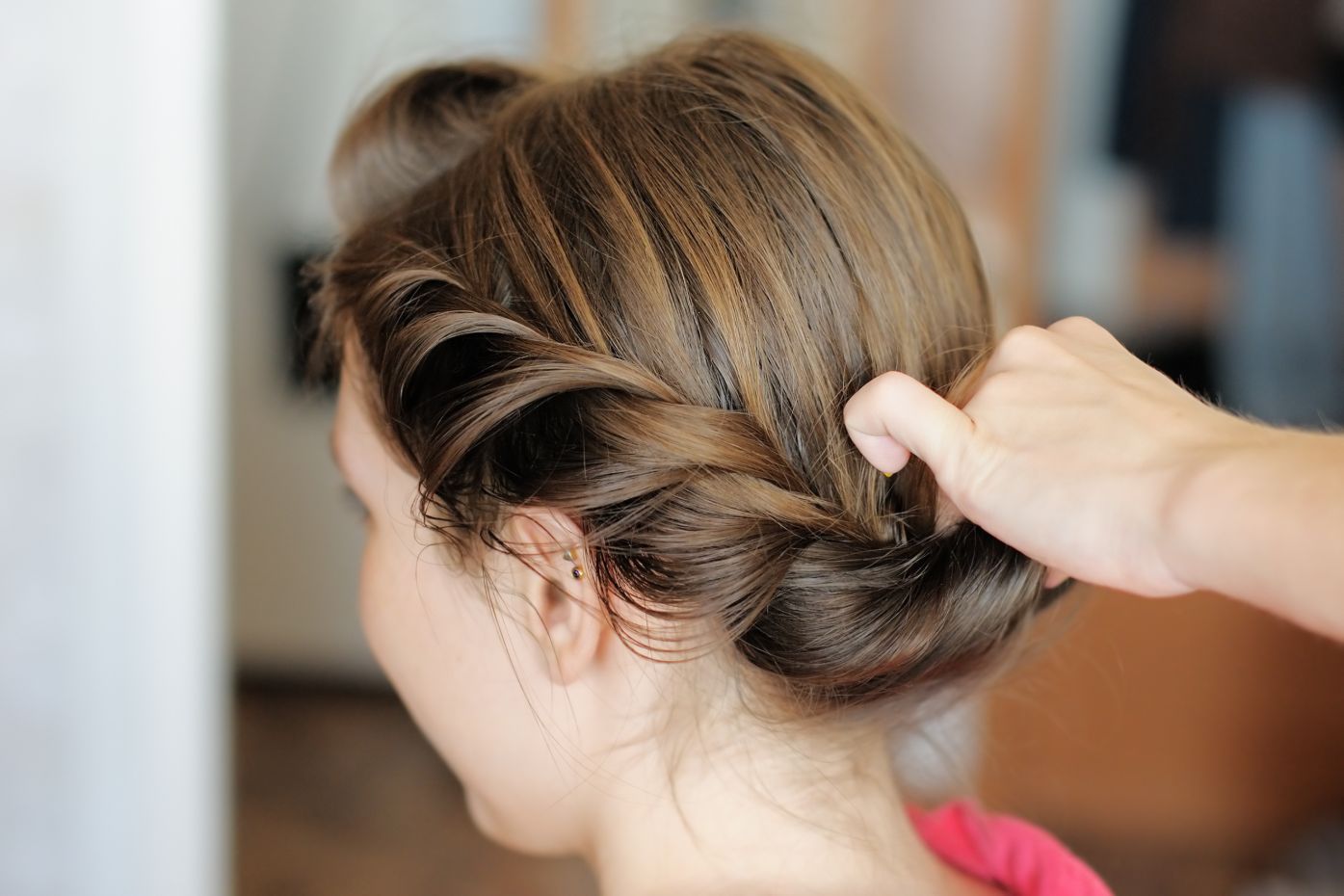 hair stylist completing plait