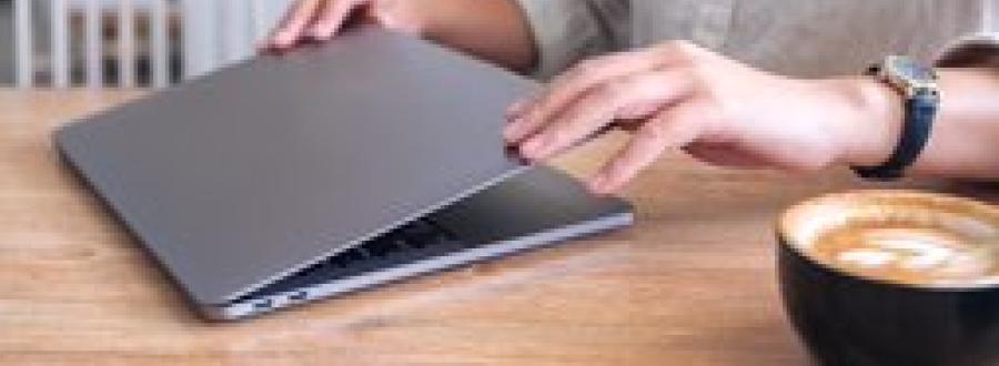 a freelance worker opens laptop in cafe