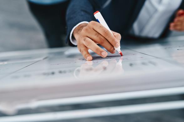 Businessman writing on a whiteboard