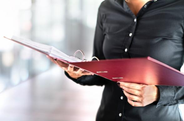 woman with red file and paper