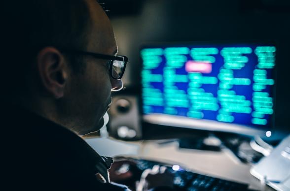 Man looking at a screen with data