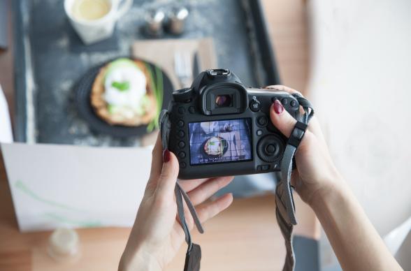 A person takes a picture of their food