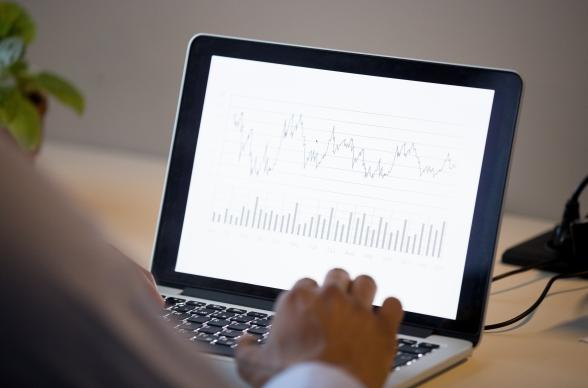 small business owner uses laptop to report on business analytics