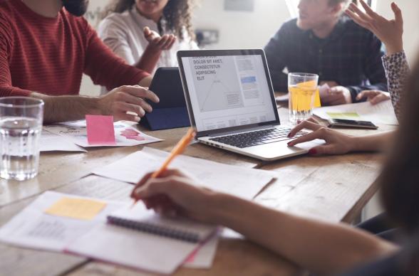 young professionals hot desk to work collaboratively