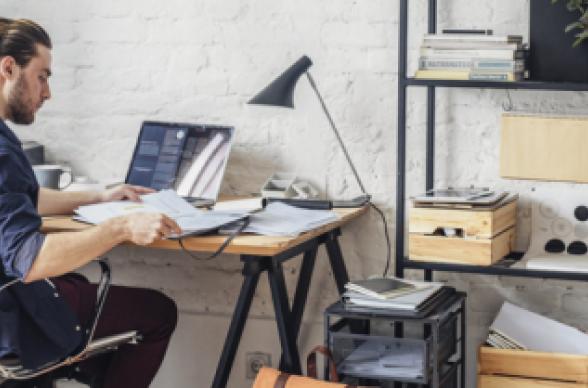 home office wooden desk shelves laptop